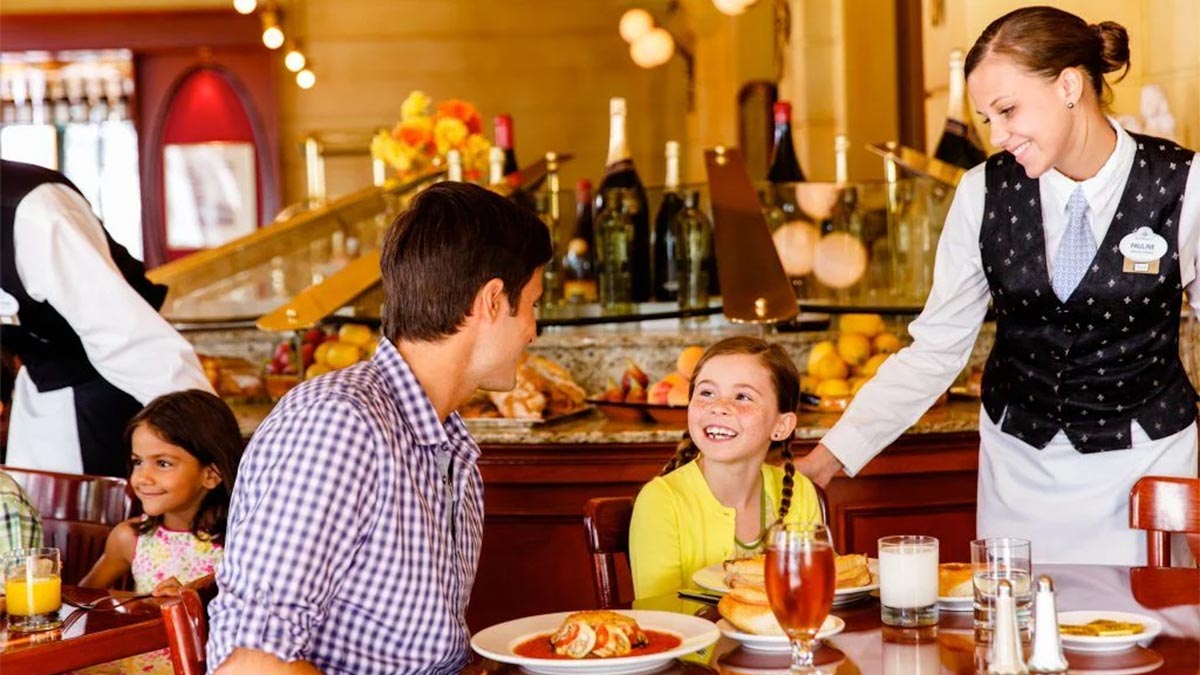 family sitting at table at Chefs de France at Epcot in Orlando, Florida, USA